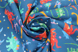 Swirled swatch Tossed Dinos fabric (dark blue fabric with tossed cartoon style dinos allover in various colours with tossed confetti style shapes)