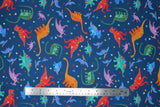 Flat swatch Tossed Dinos fabric (dark blue fabric with tossed cartoon style dinos allover in various colours with tossed confetti style shapes)