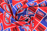 Swirled swatch licensed NHL fabric in Montreal Canadiens (quilt squares pattern with red and blue backgrounds with logo, red background with team text)