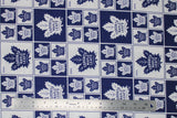 Flat swatch licensed NHL fabric in Toronto Maple Leafs (quilt squares pattern with blue and white backgrounds with opposite colour logo in each square)