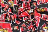 Swirled swatch licensed NHL fabric in Ottawa Senators (quilt squares pattern with red and black backgrounds with logo, black background with team shield, red background with black "O")