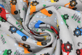 Swirled swatch comfy print flannel in tractor (blue/yellow/orange/green/red tractors on light grey)