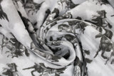 Swirled swatch comfy print flannel in horses (black and grey running horses on light grey)