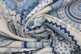 Swirled swatch upholstery fabric (blue mandalas print: assorted circular mandala shapes in light to dark blues on beige fabric)