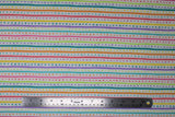 Flat swatch Dots & Stripes fabric (white fabric with rainbow coloured dots and stripes in horizontal alternating stripes)