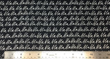 Flat swatch cursive writing bla bla bla fabric in black (black fabric with white "bla bla bla" cursive writing allover in neat lines)