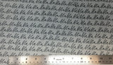 Flat swatch cursive writing bla bla bla fabric in grey (grey fabric with black "bla bla bla" cursive writing allover in neat lines)