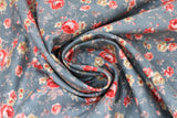 Swirled swatch Farmhouse Chic floral fabric (faded blue denim look fabric with small and medium tossed floral allover in pale red, cream, blue with leaves and greenery in pale tones)