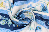 Swirled swatch Stripe fabric (white and dark blue stripes separated by thin light blue stripes all with blue and white floral within and tossed yellow insects)