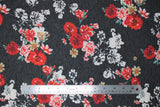 Flat swatch black/red roses jersey knit fabric (charcoal fabric with white flower silhouettes and red colourway flower clusters)