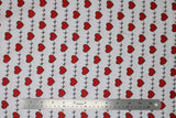Flat swatch hearts and heartbeat lines printed fabric on white (red hearts and black lines on white)