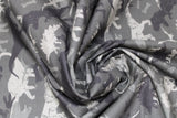 Swirled swatch camo dinosaur printed fabric in dark green camo (multi dino on faded green)