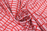 Swirled swatch Marvel Brick fabric (red fabric with white 'MARVEL' logo allover in diagonal neat lines)