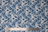 Flat swatch woodland themed fabric in stacked wolves (white/blue/grey drawn wolf heads collage yellow eyes)