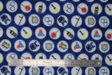 Flat swatch Gadgets fabric (blue textured look fabric with large white circular badges allover outlined in light blue with police related emblems within/cartoon style: vests, cuffs, stop signs, etc.)