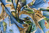 Swirled swatch Postcards fabric (scattered raw edge postcards with brightly coloured underwater fish graphics over barn board look collage with tossed fishing lures and netting)