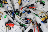 Swirled swatch Tossed Golf Carts fabric (white fabric with tossed green, red, blue and yellow golf carts and flags, tossed golf balls and clubs)