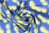 Swirled swatch garden gnome themed fabric in lanterns (medium blue fabric with scalloped cartoon yellow lit lanterns on strings with red/green/yellow tops)