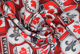Swirled swatch Canadian signs red fabric (red fabric with tossed collaged Canadian badges and signs in white, red, black, grey with "Canada", flags, Highway 1, etc.)
