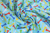 Swirled swatch comfy print flannel in bones (multi-coloured dog bones on light blue)