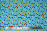 Flat swatch comfy print flannel in bones (multi-coloured dog bones on light blue)