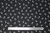 Flat swatch skulls fabric in black (black fabric with white small skull and crossbones tossed allover)