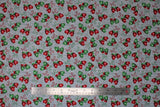 Flat swatch Mittens fabric (grey fabric with subtle white snow dots allover and busy tossed green and red winter mittens attached with string all have a white snowflake on them)