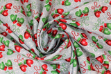 Swirled swatch Mittens fabric (grey fabric with subtle white snow dots allover and busy tossed green and red winter mittens attached with string all have a white snowflake on them)