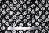 Flat swatch Jackolantern fabric (black fabric with white jackolantern pumpkins allover with various faces, some with witch hats, some white faces only poking through black)