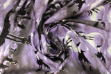 Swirled swatch Creatures of the Night fabric (purple and grey misty look sky fabric with black silhouette graphic of graveyard with hand sticking out of ground and witch flying over)