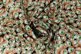 Swirled swatch I See You fabric (green eyes in brown spherical eye sockets tossed allover)