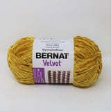 Ball of Bernat Velvet yarn in shade Golden Moss (bright mustard yellow/gold)