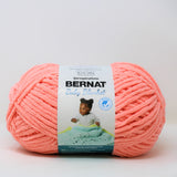 A ball of Bernat Baby Blanket yarn in shade Coral Blossom (peach coral)