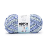 Ball of Bernat Baby Blanket yarn in shade Lovely Blues (pale blue shades in light to dark)