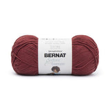 A ball of Bernat Softee Cotton yarn in shade Juniper (pale dark red)
