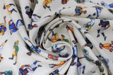 Swirled swatch players white fabric (white fabric with small tossed full colour football players in various coloured uniforms/positions, etc.)