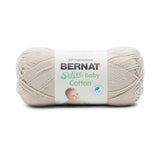 A ball of Bernat Softee Baby Cotton yarn in shade feather grey (pale grey/beige)