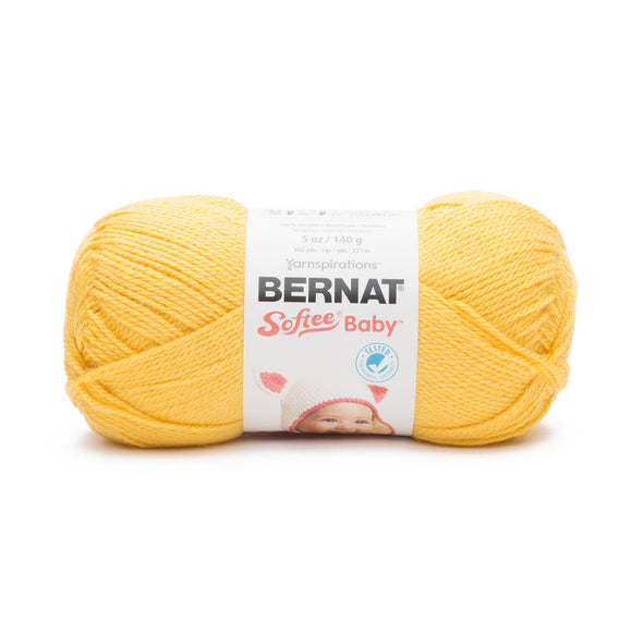 A ball of Bernat Softee Baby yarn in bright yellow shade on white background