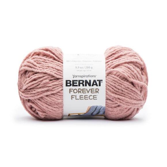 A ball of Bernat Forever Fleece yarn in shade Rose Hip (pale blush pink)