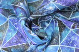 Swirled swatch geometric print fabric (assorted sized triangle fabric with light blue separating lines and dark blue and white star galaxy backgrounds within)