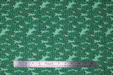 Flat swatch Trees fabric (light green fabric with tossed green evergreen style drawn look trees allover some with red berries)