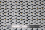 Flat swatch Trees fabric (white fabric with diagonal lines of black triangle tree silhouettes with tossed gold sparkle stars)