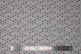 Flat swatch Trees fabric (light grey fabric with tiny tree silhouettes allover in white, grey, green, reds)
