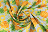 Swirled swatch Pinapple Toss fabric (pale blue fabric with tossed full and sliced pineapples allover)