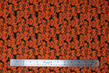 Flat swatch Jack fabric (black fabric with small tossed orange jack-o-lantern pumpkins allover in various sizes and facial expressions)