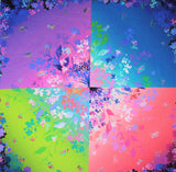 Full panel swatch bright floral print in blocks (22" x 22" square panel) (Purple, blue, pink, and green squares compose entire panel with splash floral design in pastels and white centered with subtle vignette floral border)
