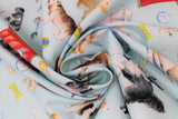 Swirled swatch dog themed fabric print think pawsitive in light blue (light blue fabric with assorted dogs, dog houses and beds, bones, balls, leashes, collars, in various colours)
