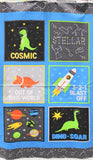 Full panel swatch Cosmic Panel (24" x 45") (blue rectangular panel with thick top and bottom stripe in black with white and yellow constellations, 6 squares within blue rectangle all showing a separate cartoon image related to space and dinosaurs with text "Cosmic" etc)