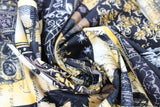 Swirled swatch halloween printed fabric in Spooky Collage (white, yellow, black colours skulls, birds, spooky patches)