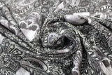 Swirled swatch halloween printed fabric in Tossed Skulls on Paisley (white and black skulls and paisley mix)